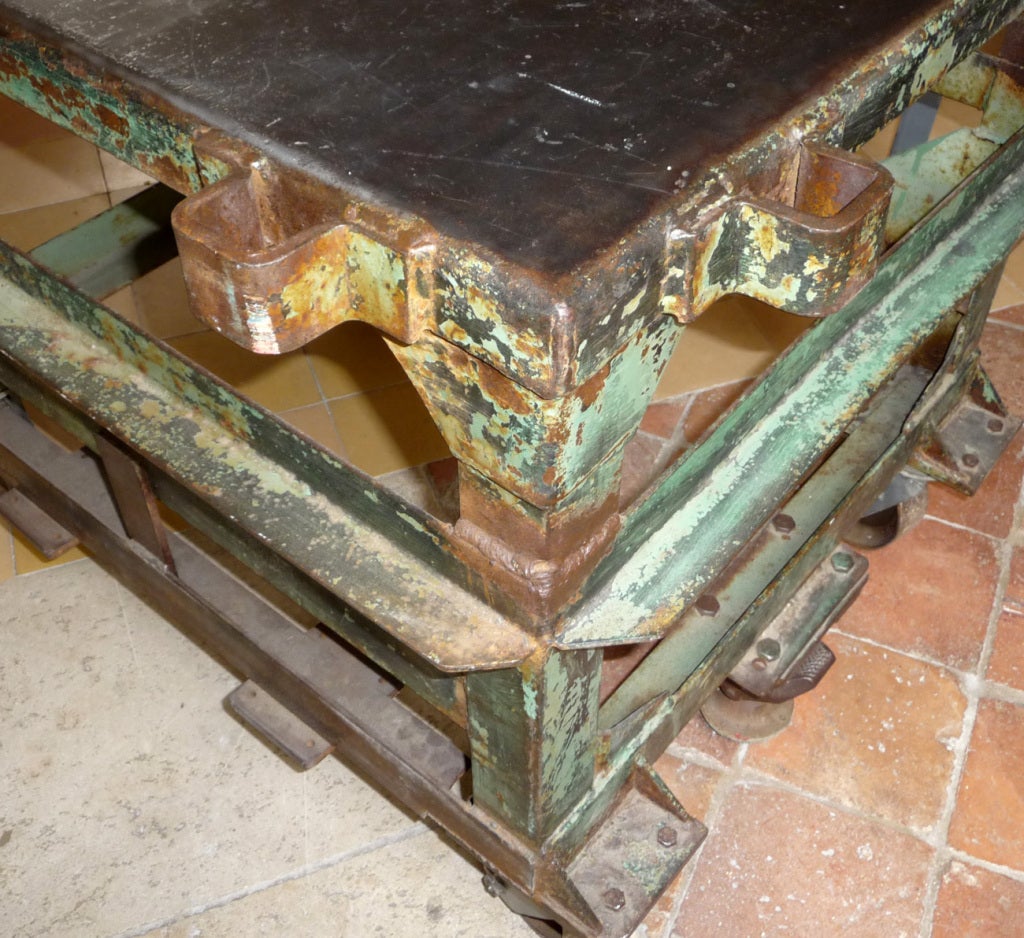 A wonderful looking rolling table / cart, with just the perfect amount of wear. A layer of light green paint wears away to expose a darker green below, to great effect. Needless to say, the table is very solid and heavy, and can support just about