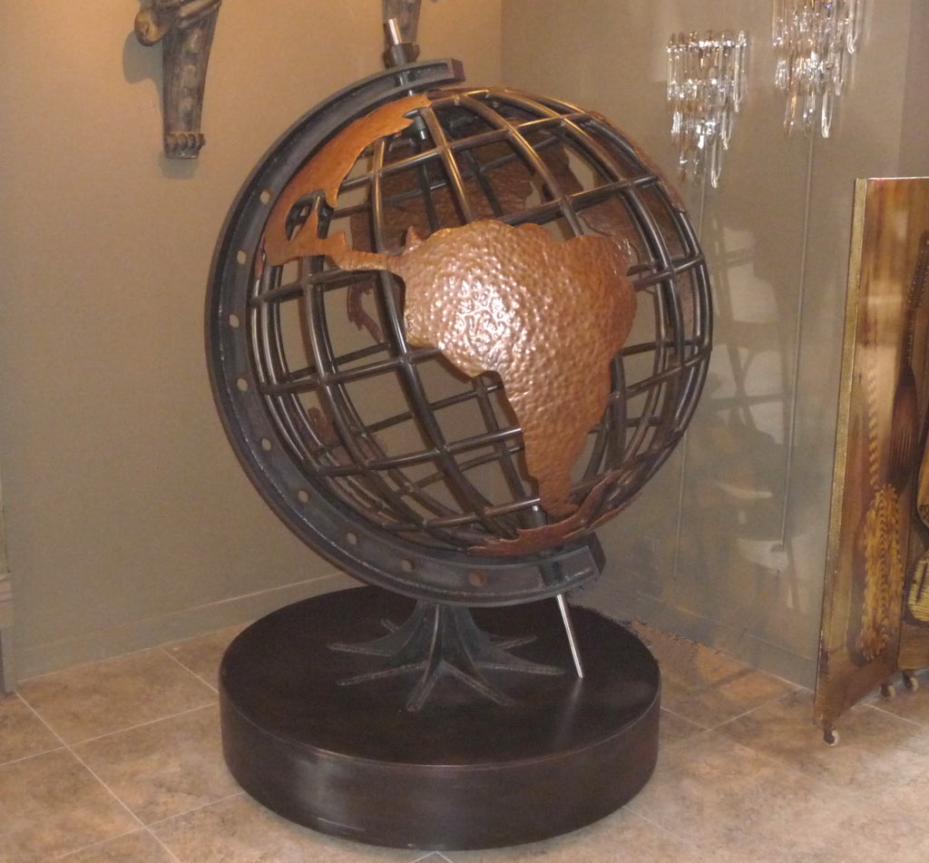At over six feet tall, this gigantic globe is as impressive as it is beautiful. Created in formed steel, each section is welded and clear finished to a wonderful effect. The continents are hand hammered copper, and applied over the surface. A 
