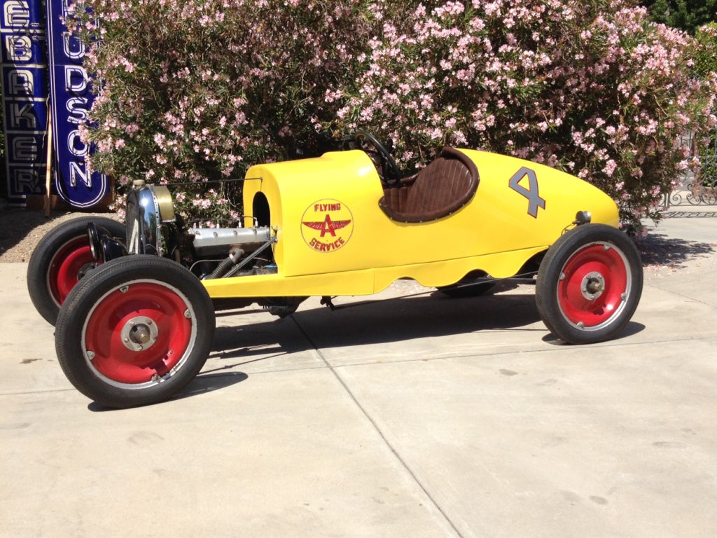 What a beauty! Here is the ultimate big boy toy - a drivable 1920's Ford hot rod in hornet yellow finish. The all metal body is a sexy teardrop, marked with racing numbers and a Flying A sponsors logo. The engine is a straight four cylinder, in