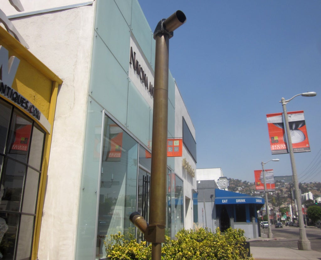 This unique decorative periscope was once employed by the U. S. Marines, and most likely used in survey operations. The periscope is all brass, while the tripod base is a combination of wood and aluminum. It appears to be all original, and displays