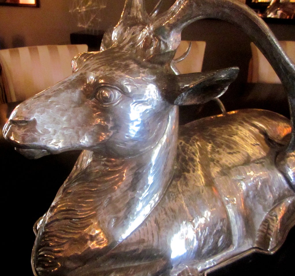 What more dramatic way to serve meats to your guests than this stylized stag? Made and signed by Franco Lafini, this beauty makes an impressive centerpiece to any table setting. The entire stag and platter are hand hammered brass, plated in silver.