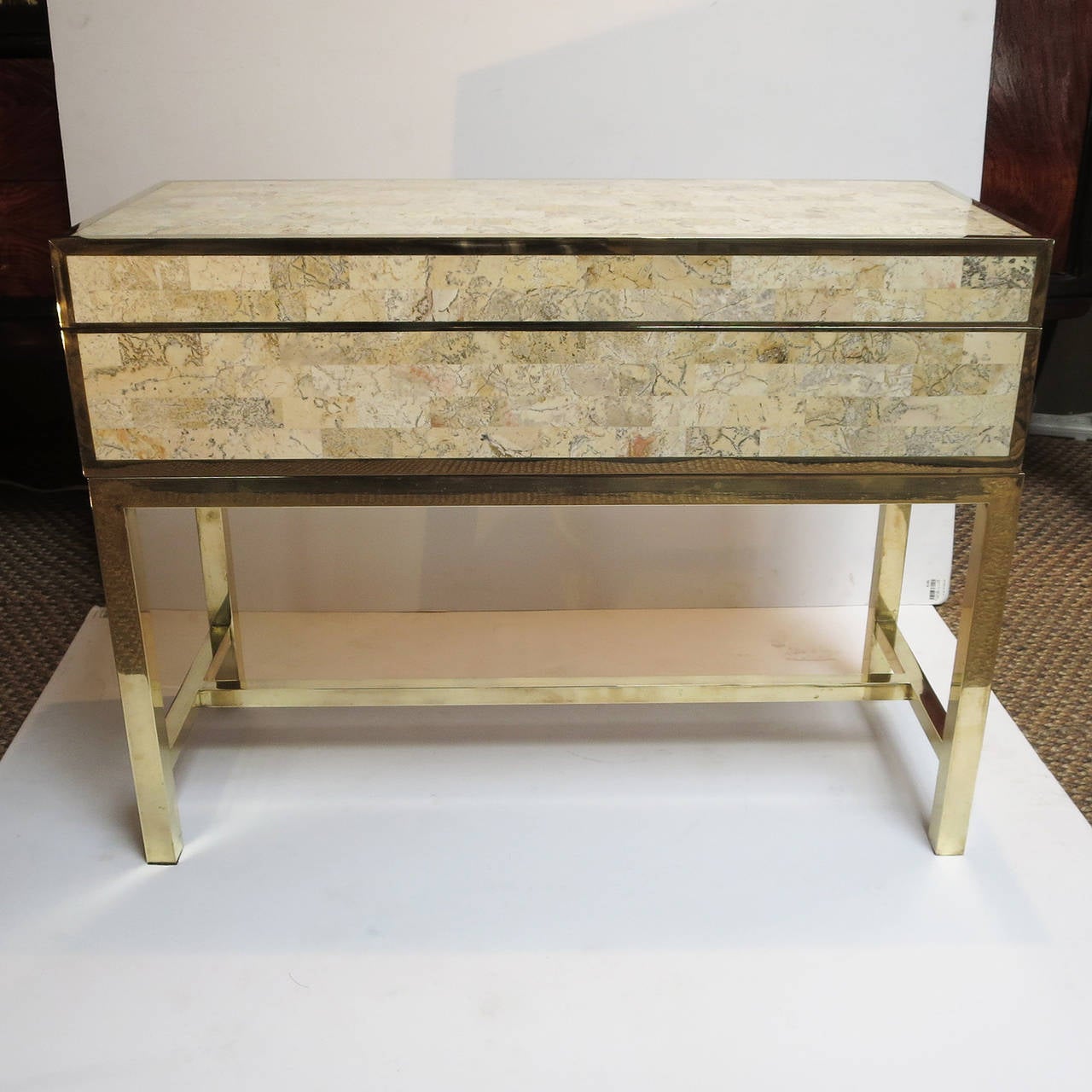 This wonderful cabinet can be placed anywhere as an occasional table or small side table. The lid hinges open to reveal an open box, lined in polished mahogany. All edges are finished in brass, and sits on a solid brass base. We have done a light