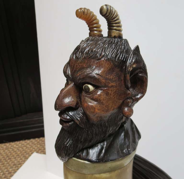 This is quite unbelievable! This intricately carved devil head and body mounts to a curved hollow horn to create a drinking flagon. The wings and hoof foot are tipped in real talons, which are still quite sharp. One foot is a cloven hoof, while one