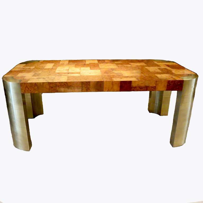 A fantastic design by Paul Evans, this lovely table comes with two extensions. The top surface is a highly figured patchwork of light and dark burled woods, finished in gloss. The curved corner legs are patchwork brass, in a contrasting satin