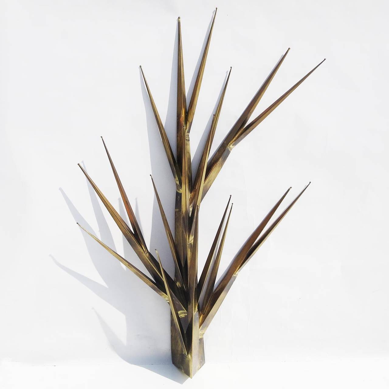 I have seen and owned many Jere sculptures over the years and have never seen anything close to this! This desert like spiny form is executed in brass and welded together. There is an overall patina to all surfaces, consistent with its age. It is
