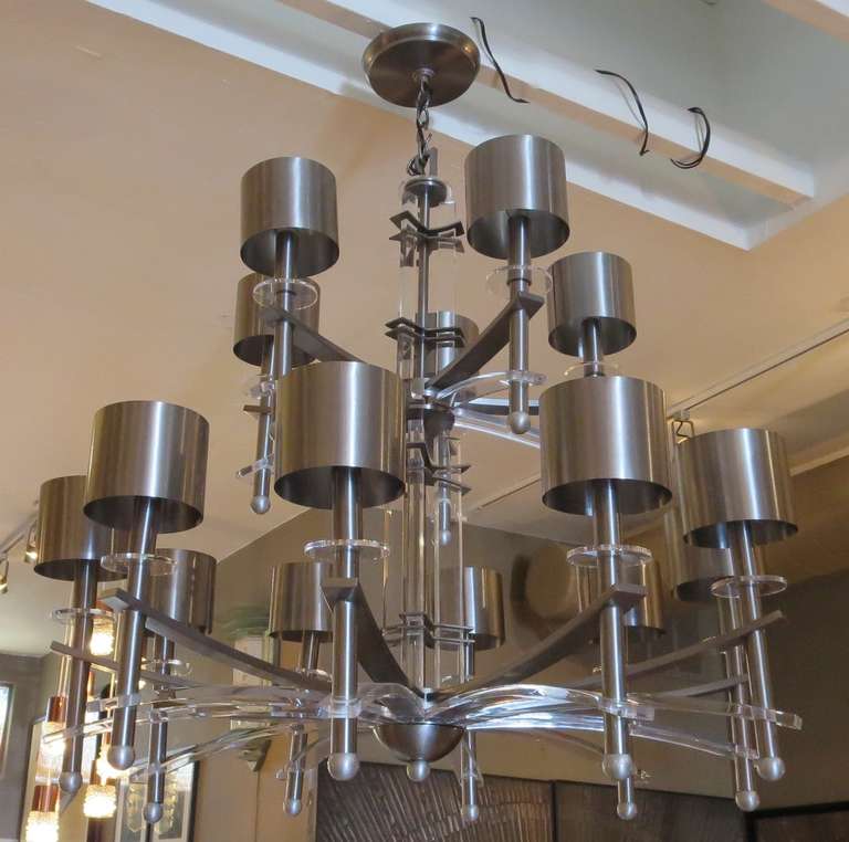 RETIREMENT SALE!!!  EVERYTHING MUST GO - CHECK OUT OUR OTHER ITEMS.				

This two tiered machine age influenced chandelier casts a commanding presence in any room it occupies. Ten large arms of brushed stainless steel and clear lucite reach out from