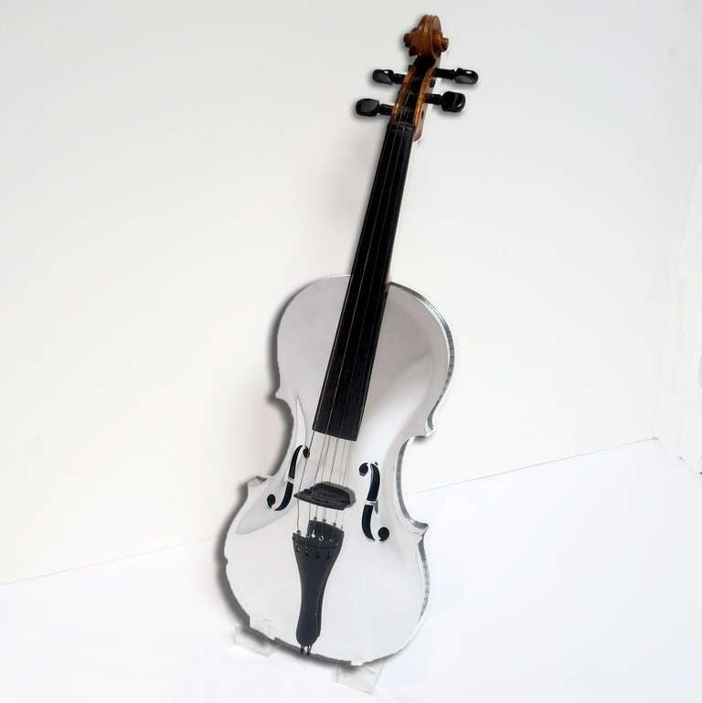 A full sized violin, complete with original wooden case. The body has been highly polished to a mirror finish. The neck is original wooden finish, and shows natural age wear. The instrument has not been tuned or tested, but appears to be complete