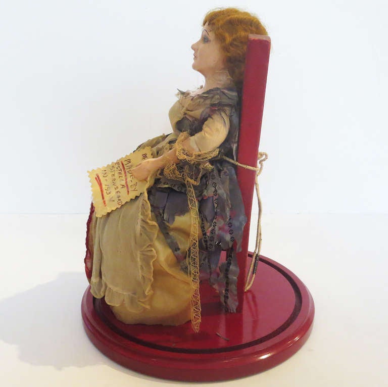 A lovely doll with painted heads and hands, and hand stitched costume. Made by Estella Steensgard in 1934, she still has her original identifying card. The doll sits on a painted wooden chair, and is enclosed in a glass dome. Who knew Ms. Ross wore