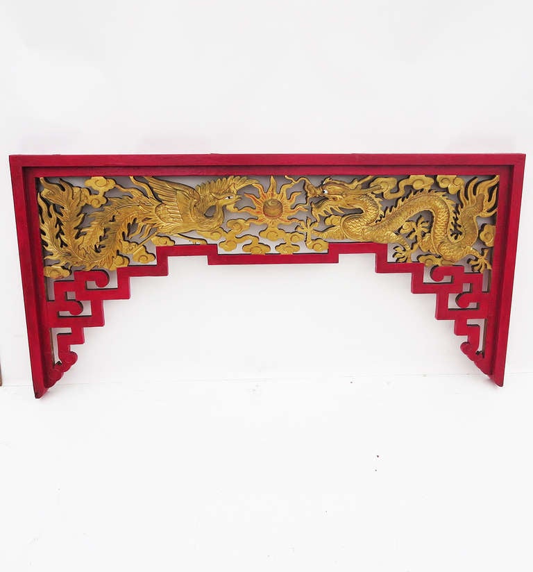 This wonderful pair are beautifully carved, and are in fantastic condition. Featuring an opposing dragon and phoenix, the wooden structures are finished on both sides, and completely painted. They were most likely created for a commercial space,