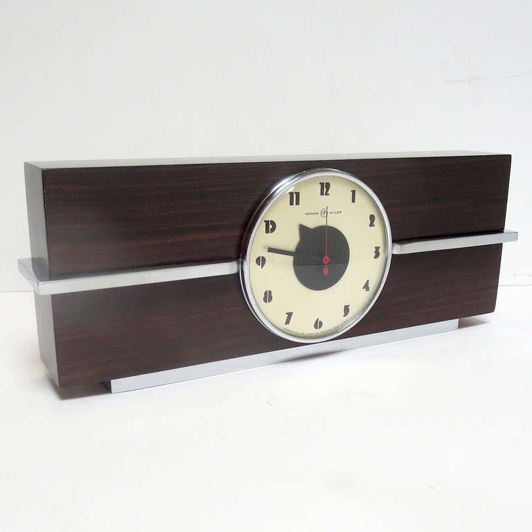 A sleek and stylish design by one of Americas' premier designers. Besides the iconic furniture designs Rohde created for Herman Miller in the 1930's, he also designed a line of clocks for the company. This large version, in rosewood and chrome, is