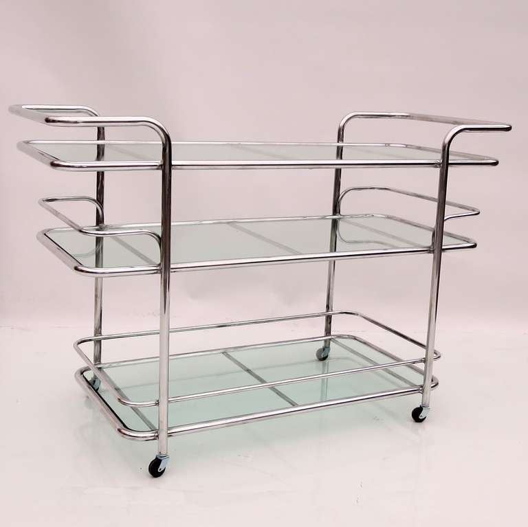 A beautiful modern design from the iconic Brown and Jordan Company. The cart is freshly polished aluminum, with obscured pebbled glass shelves. The cart will work well indoors or outside, in any setting, from 1930s Art Deco to ultra modern.