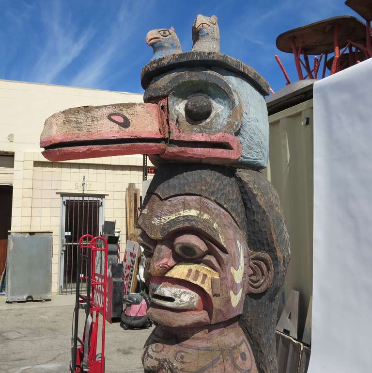 This marvelous pair of hand carved painted totem pole sculptures once graced the estate of Robin Leach, best known as the host of 