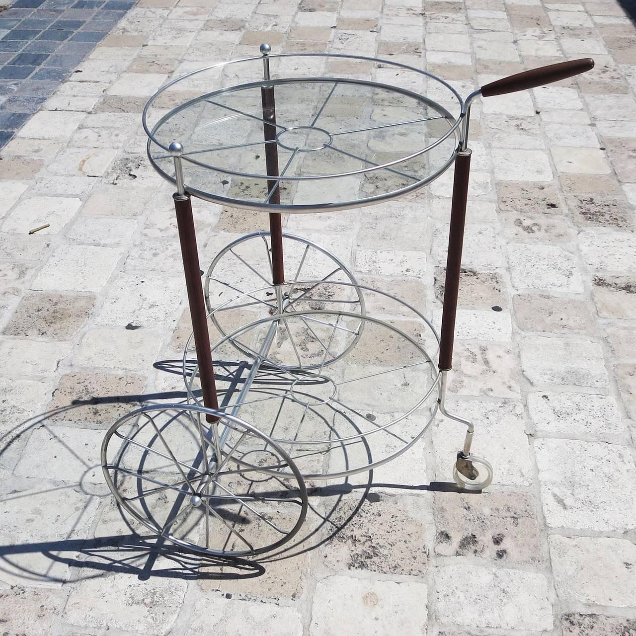 RETIREMENT SALE!!!  EVERYTHING MUST GO - CHECK OUT OUR OTHER ITEMS.				

This circular trolley with its oversized wheels is a great play on proportion, indeed. All metals are silver painted, contrasting with darkened and polished mahogany accents.