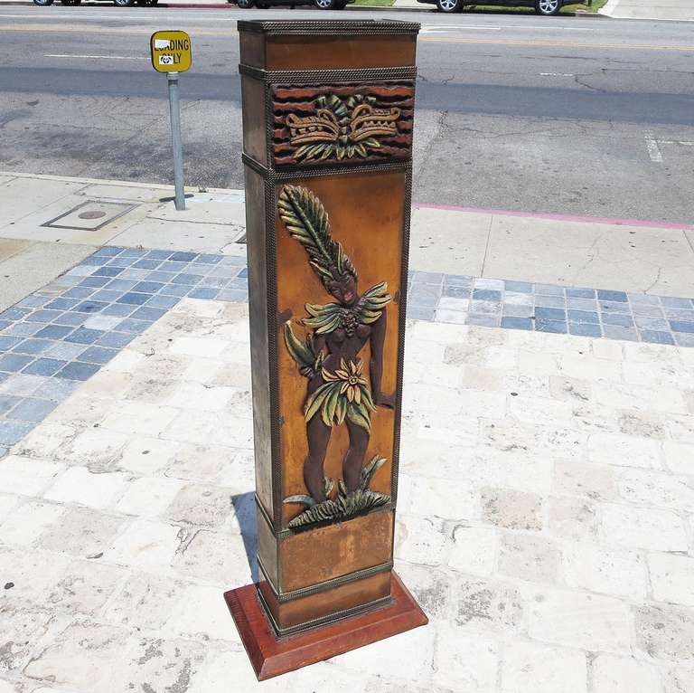 A wonderful and whimsically exotic design, this may have been made for a restaurant or night club of the period. The dancing native and flora decorations are a painted carved material. The structure is copper, with braided chain trim. The base is