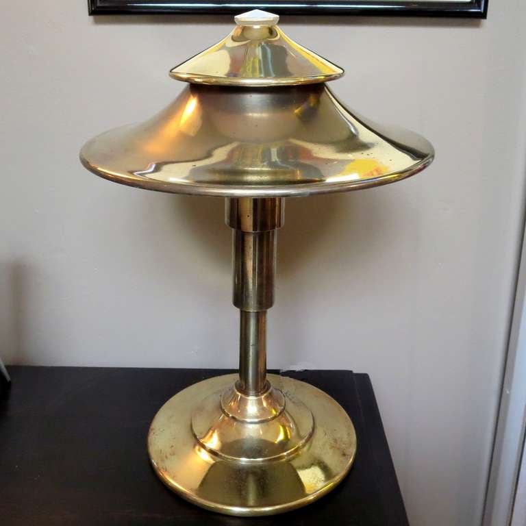One of the truly iconic designs of the 1930's is this tiered table lamp, designed by Kem Weber for the Miller Lamp Company. It is pictured in a number of important Art Deco books on the period. The light passes through both tiers of the shade, as