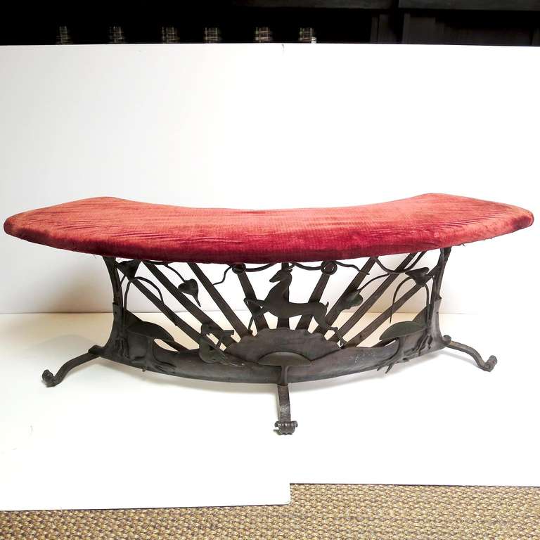 This lovely circular bench suggests the stylings of William Hunt Diederich, with a stylized leaping stag in the center. Also featured are a figure of Pan with his flute, and stylized mushrooms and vines. The metalwork is all hand forged, and