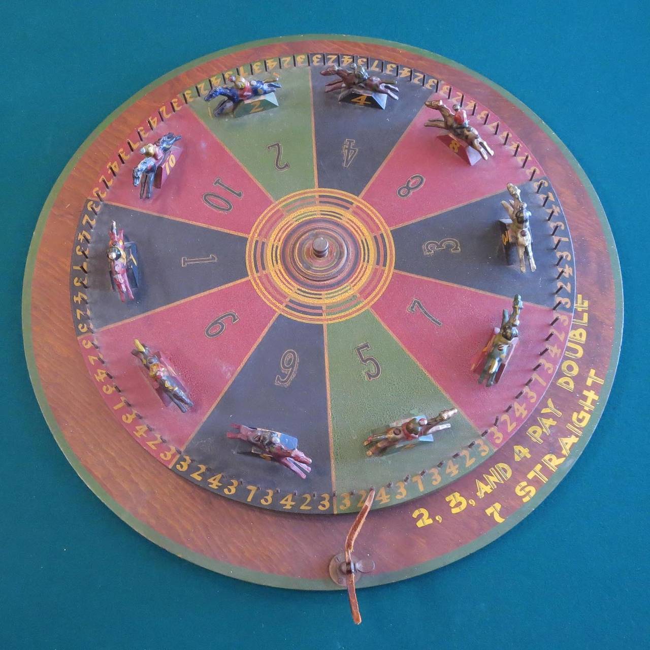 This charming horse racing game was often used on sea cruise ships, as they were portable and easy to set up once in legal gambling waters. The wheel spins very freely, and lands on one of the numbered horses to win. Numbers, 2, 3 and 4 pay double.