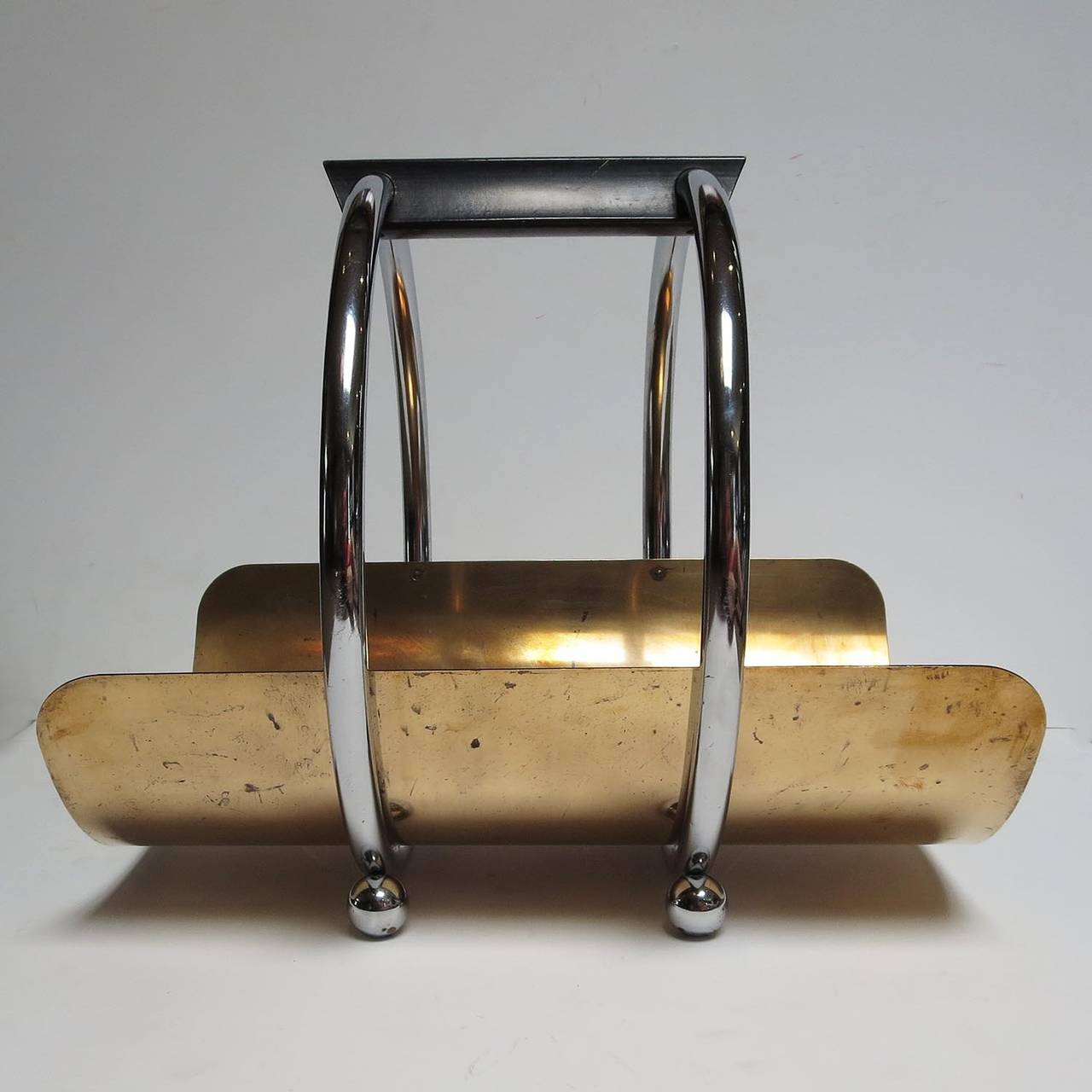 An icon of modern Art Deco design, this stylized log holder is often misattributed to Norman Bel Geddes. It was designed by Leslie Beaton for the Revere Copper and Chrome Company in 1936.The belly of the holder is a single sheet of copper-plated
