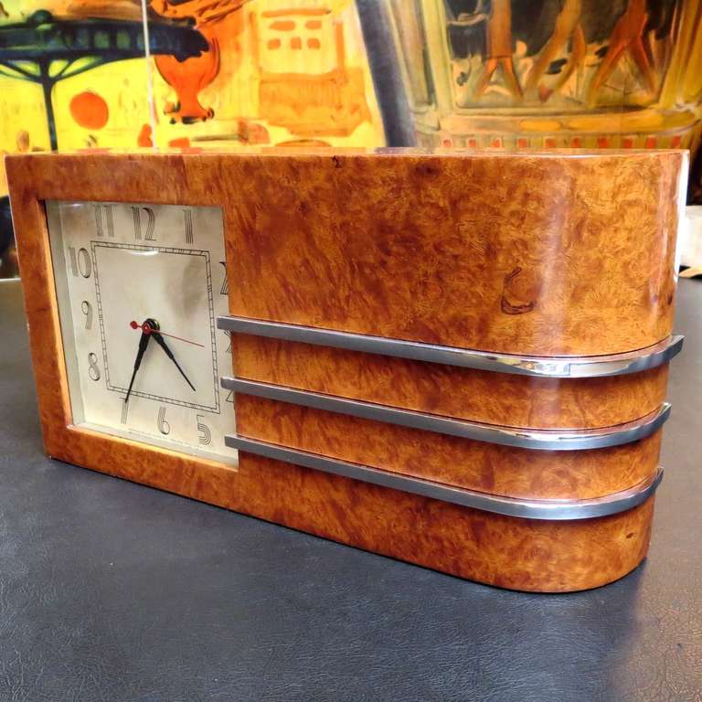 The first designs created by Gilbert Rohde for the Herman Miller Company were debuted at the Chicago Worlds Fair of 1933-1934. Our lovely burled wood clock has an original identification label dating it at 1934. These were quite revolutionary