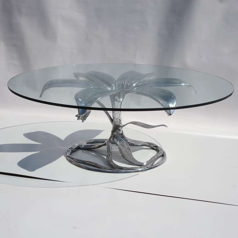 While most of these tables surface with a painted gold finish, ours came in a natural aluminum. We have had it highly polished, and it looks terrific! A large circular glass top adds to the overall effect, and is in very clean condition, as well.
