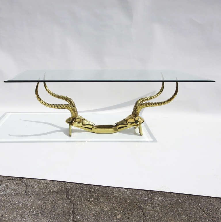 A lovely table in polished brass by Dickran for the Fondica company of France. 
Table is in excellent condition with beveled glass top, and original signature and markings.