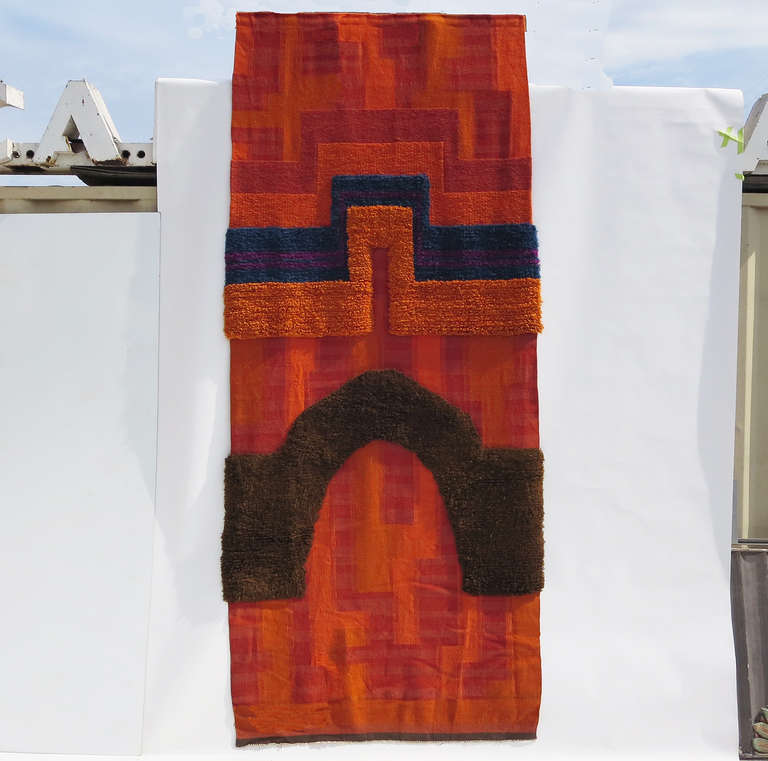 An amazing work in execution and scale! The brightly colored tapestry can be used as a rug or wall hanging. The body is tightly woven wool, with a similar thickness and texture of a Navajo rug. The thicker areas are a deeper plush, much like thick