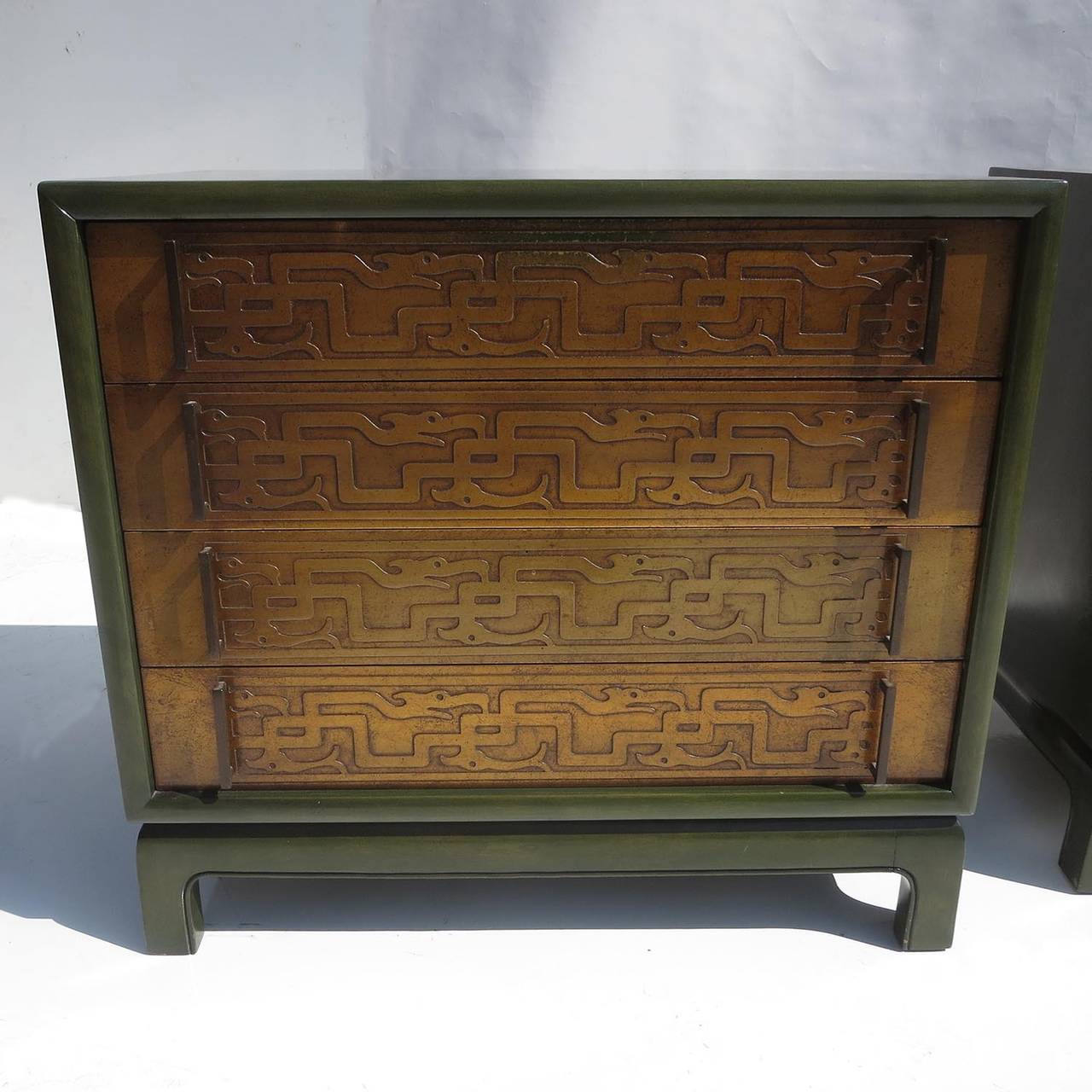 This lovely pair are painted birch in a deep dark green finish, including the back sides. The drawer faces are carved in a dragon motif, and finished in a burnished gold tone. All handles are cast bronze. The interiors of the drawers are finished in