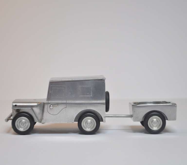 After the German defeat in World War Two, local industries were set up to employ the German craftsmen. With the excess of surplus metals, many decorative objects were created for export. This charming jeep opens up to expose a cigarette box, and by