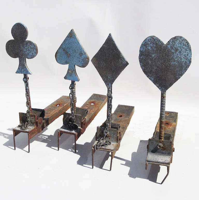 This wonderful set of shooting targets represent the four suits of playing cards: Hearts, Diamonds, Spades, and Clovers. They are heavy gauge steel, with faded remnants of a one time painted finish. Each target has two spikes in front, which were to