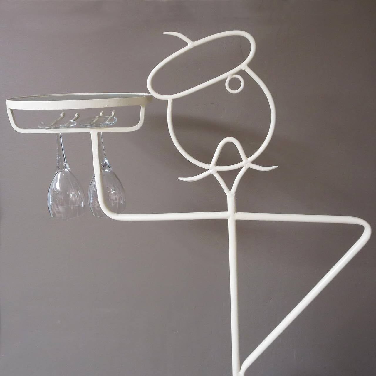What better way to enjoy a bottle of your favorite French wine than from this beret topped French waiter? This whimsical sculpture is freshly painted steel, and looks great. The legs can accommodate up to fourteen bottles of a standard size. The