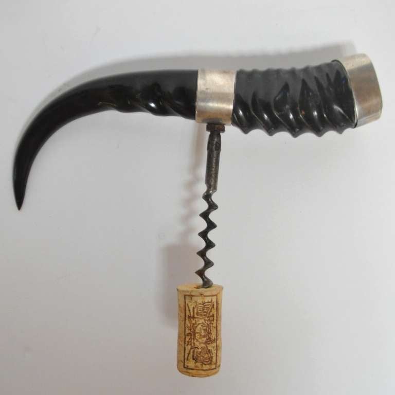 Beautiful, polished Africa horn banded in sterling silver to create this lovely, decorative corkscrew. A great gift item and handsome addition to any bar top.