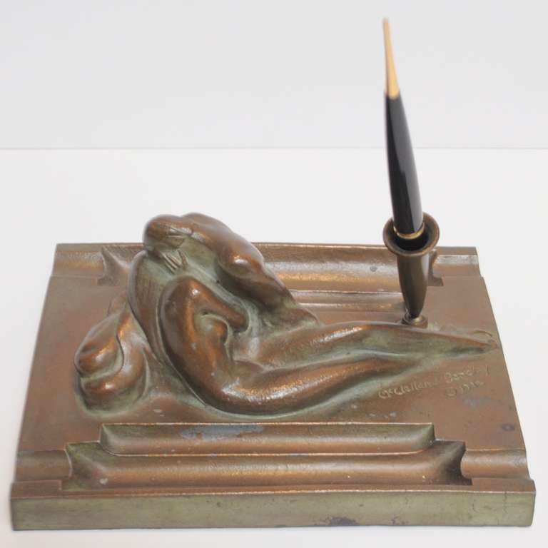 The artist McClelland Barclay is well known for his war time, political recruitment posters. This lovely sculptural pen holder depicting two embracing nudes is signed and dated 1932. It is bronzed finished over cast metal and shows overall patina of