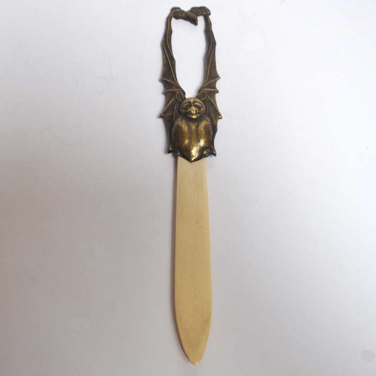 This wonderful winged bat is stylish enough for Bela Lugosi's desktop. The larger bat is clutching a small baby bat in its claws. The bat is in finely cast bronze with a polished ivory blade. The opener is in very fine, original condition and