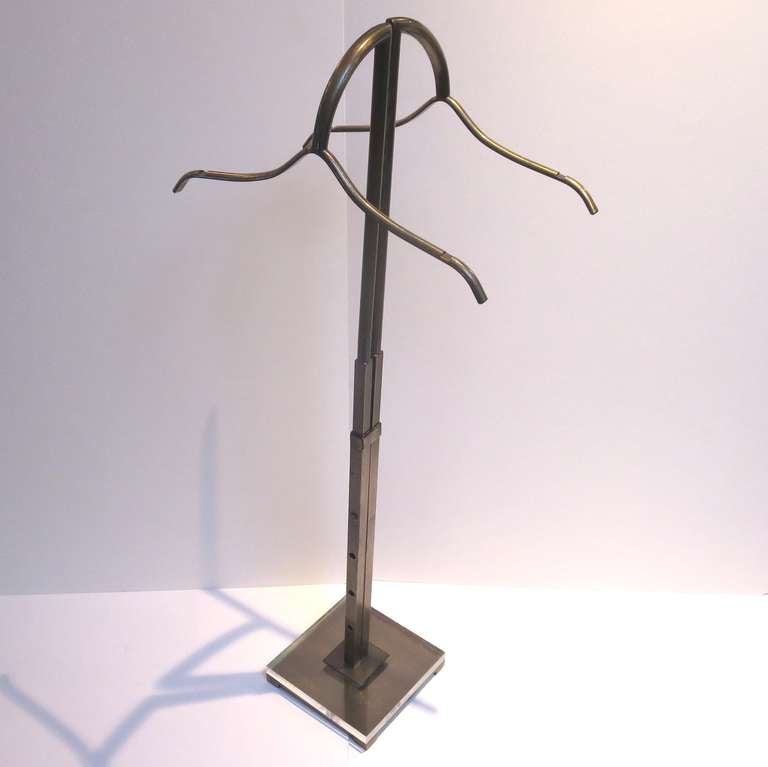A very tasteful design and classic form. Each side adjusts four positions independent of the opposite side. The hangers are notched to accommodate a spaghetti strap dress, as well. All metal is finished in a burnished and coated bronze, and the base