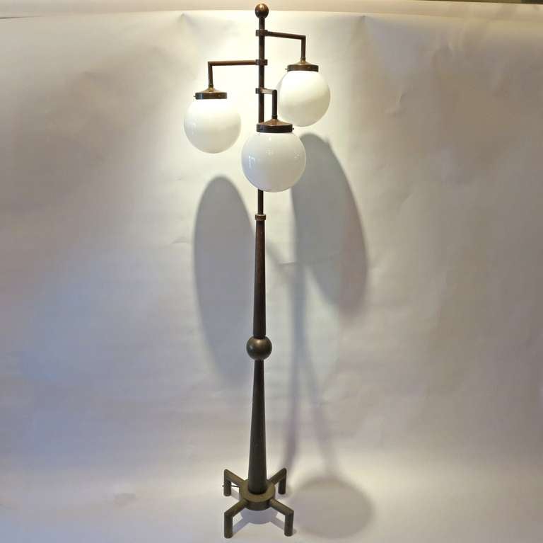 This marvelous lamp, by unknown designer, is a modern take on a classic street lamp form. The proportions are fantastic, enhancing the overall design. All light work with a single floor switch, and has been rewired with new black cloth cord. All