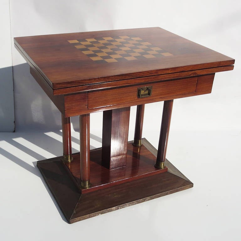 This charming table is French in origin, and dates from the 1930's. It displays a warm original patinated finish. The top folds over, doubling in length for other games besides chess. There is a single drawer for game storage or chess figures. The