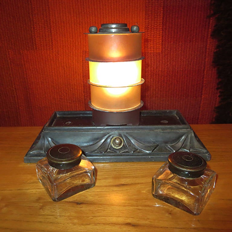 Truly contradictory, this charming set is both modern and old fashioned at the same time! The center lamp is a nod to Machine Age designs of the period, while the base is draped and almost Victorian in appearance. Not to mention that inkwells and