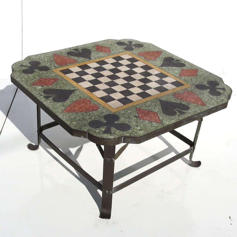 A wonderful (and heavy!) coffee table height table decorated in a suits of cards motif, surrounding a chess board. The legs and frame are all bronze, displaying a great patina of age. The table can be used indoors or outside. The terrazzo top shows