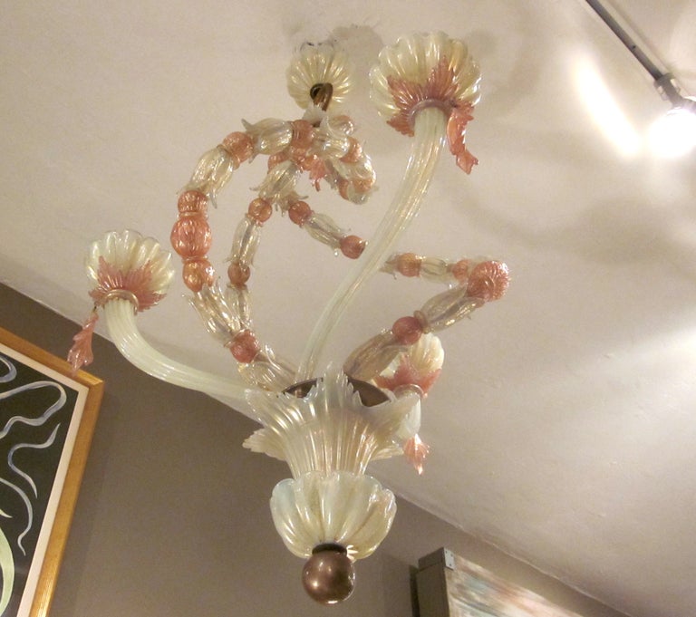 This beautiful chandelier was created by Venini glassworks of Italy in the 1950's. Three undulating 