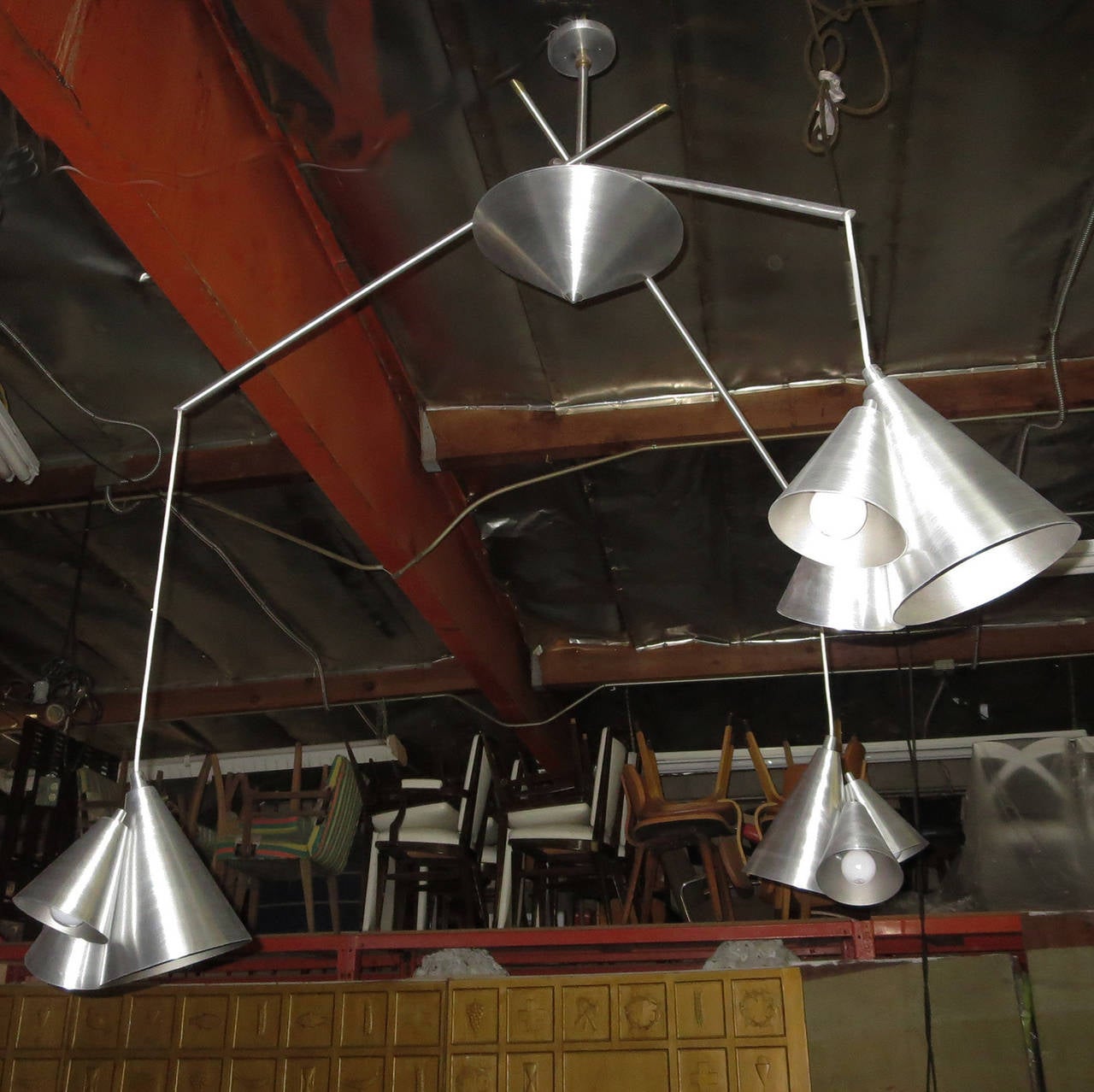 RETIREMENT SALE!!!  EVERYTHING MUST GO - CHECK OUT OUR OTHER ITEMS.				

A fantastic fixture by an unknown designer! The lamp mounts from a central pole, and feeds down into a central cone of brushed aluminum. Three arms intersect, and flare outward