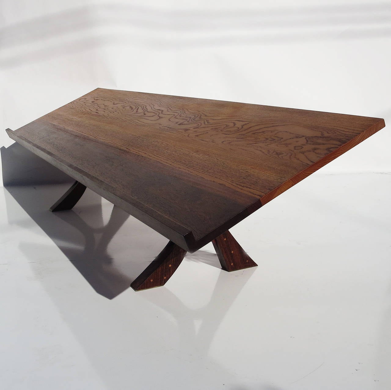 This wonderful studio table was created with the influence of George Nakashima in its' construction. The top is a combination of two woods, oak and rosewood. The legs are all rosewood, with pegged holes of a lighter wood. The finish is a satin