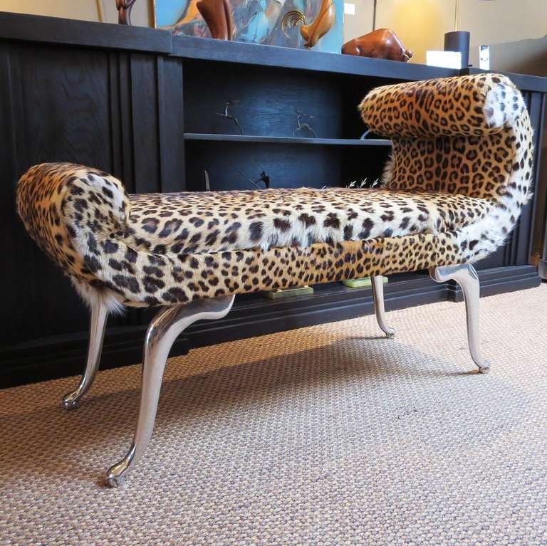 How stylish is this? This lovely bench is antique leopard with solid aluminum legs that have been highly polished. This petite chaise is sure to make an exotic statement in any room it is placed in.