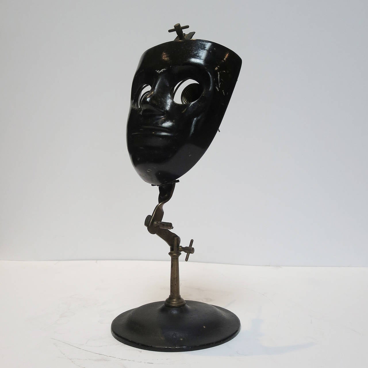 Used in the late 1800s-early 1900s, this painted metal mask was used in training budding eye surgeons. Pig’s eyes were inserted into the clamps in the eye cavities, allowing the student to perfect his surgical cutting technique. There are various