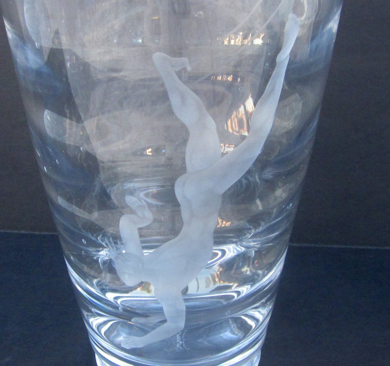 Vicke Lindstrand (Swedish 1904-1983) was considered the Father of Swedish modern glass design. This vase, the Pearl Diver, was created for Sweden's Orrefors crystal company in 1930. The etched male nude diver seems to float over the glass, to great