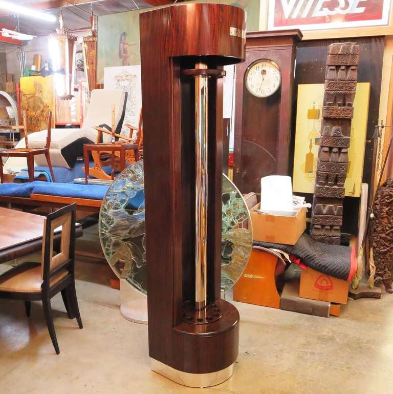 A fantastic streamlined design that ended far too soon! This rare refinished mahogany tower holds twelve of your favorite cue sticks in a stylish display. The center carousel freely revolves to access all twelve cue sticks. We have refinished the