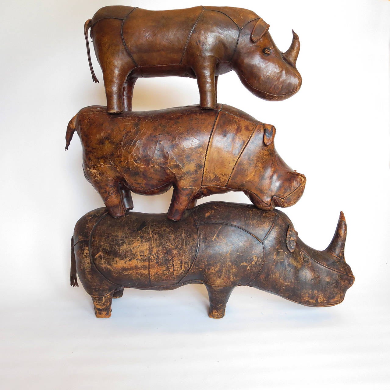 Here's a unique opportunity to gather your own herd of Abercrombie animals in one place! Deigned in the 1960s for Abercrombie and Fitch, the animals were meant as footstools. They are all leather covered, and show appropriate wear of age. The hippo