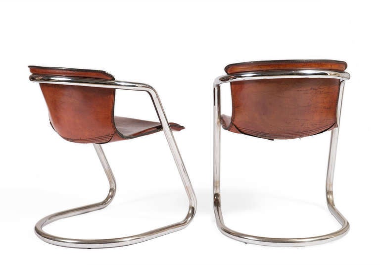 Pair of polished chrome bent frame chairs with antique leather bucket seats and double stitch detail.