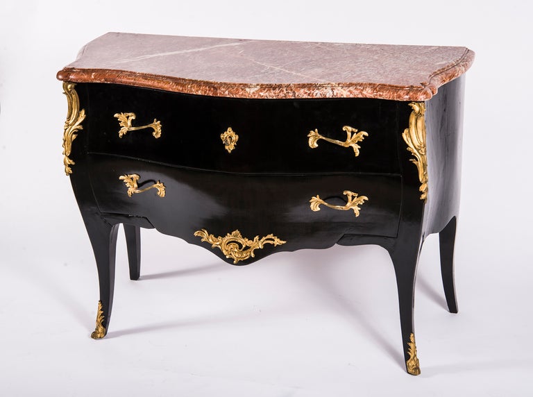 Variegated rouge marble top above case fitted with two drawers, raised on splayed legs ending in sabots. Custom handles and escutcheon. Top stamped ‘Durand Fils a Paris’.
