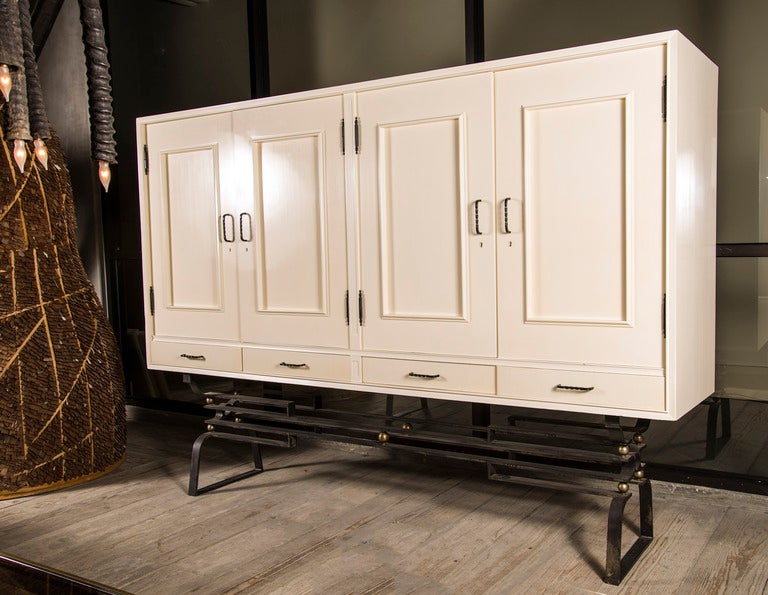Large scale dresser/cabinet with four panel doors and drawers underneath, left door opens to undergarment drawers. Maple with french polish resting on Hoffman-esque iron stand with polished brass details, wrought iron hardware throughout.