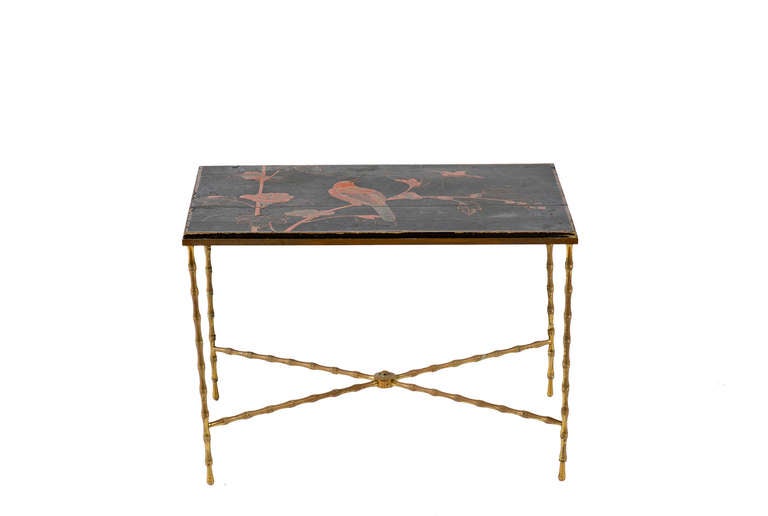 Chinoiserie lacquered wood panel top with bird motif on bamboo formed brass base, attributed to Bagues.
